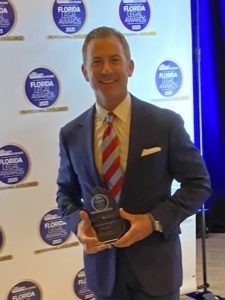 Dan Dolan holding award