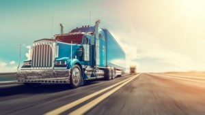 blue semi truck on the road