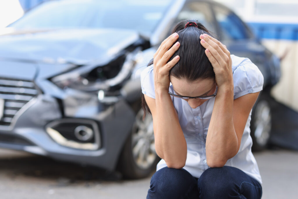 A young woman hurting after being in a fender bender car accident