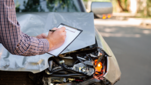 man writing out the claims process for a car crash