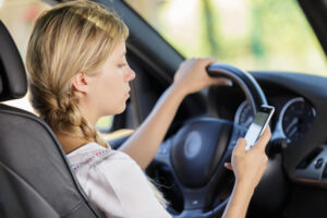 a woman texting while driving