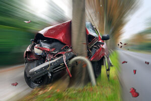 a car crashing at full speed into a tree