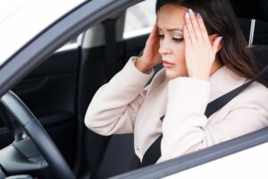a woman putting her hands on her head after a car accident in Oviedo, FL