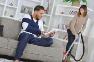young man with injured arm at home