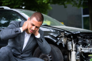 injured man holding his neck after a car accident