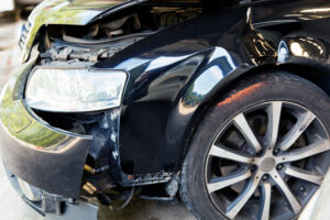 a car with body damage after an accident in a garage
