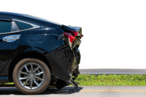 Back side of black car get damaged by accident on the road. Isolated on white. Saved with clipping path