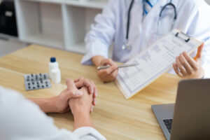 Visiting a doctor concept A doctor doing a health check by asking some questions to the patient