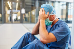 a doctor holding his head after medical malpractice in Kendall, FL